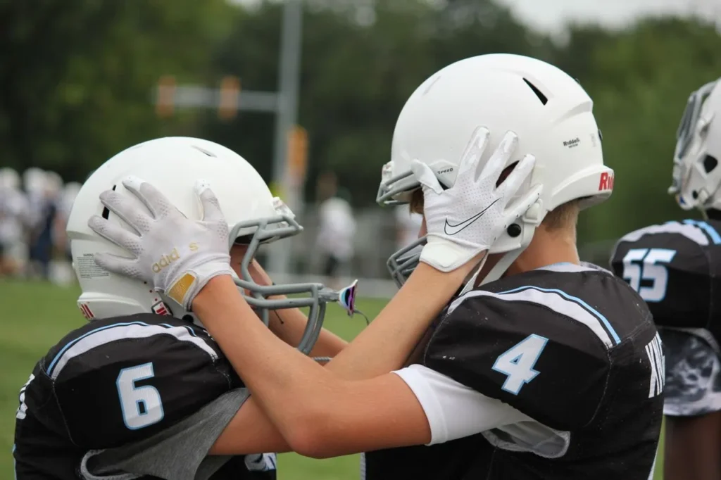 American football gloves engineered with legal grip enhancement technology